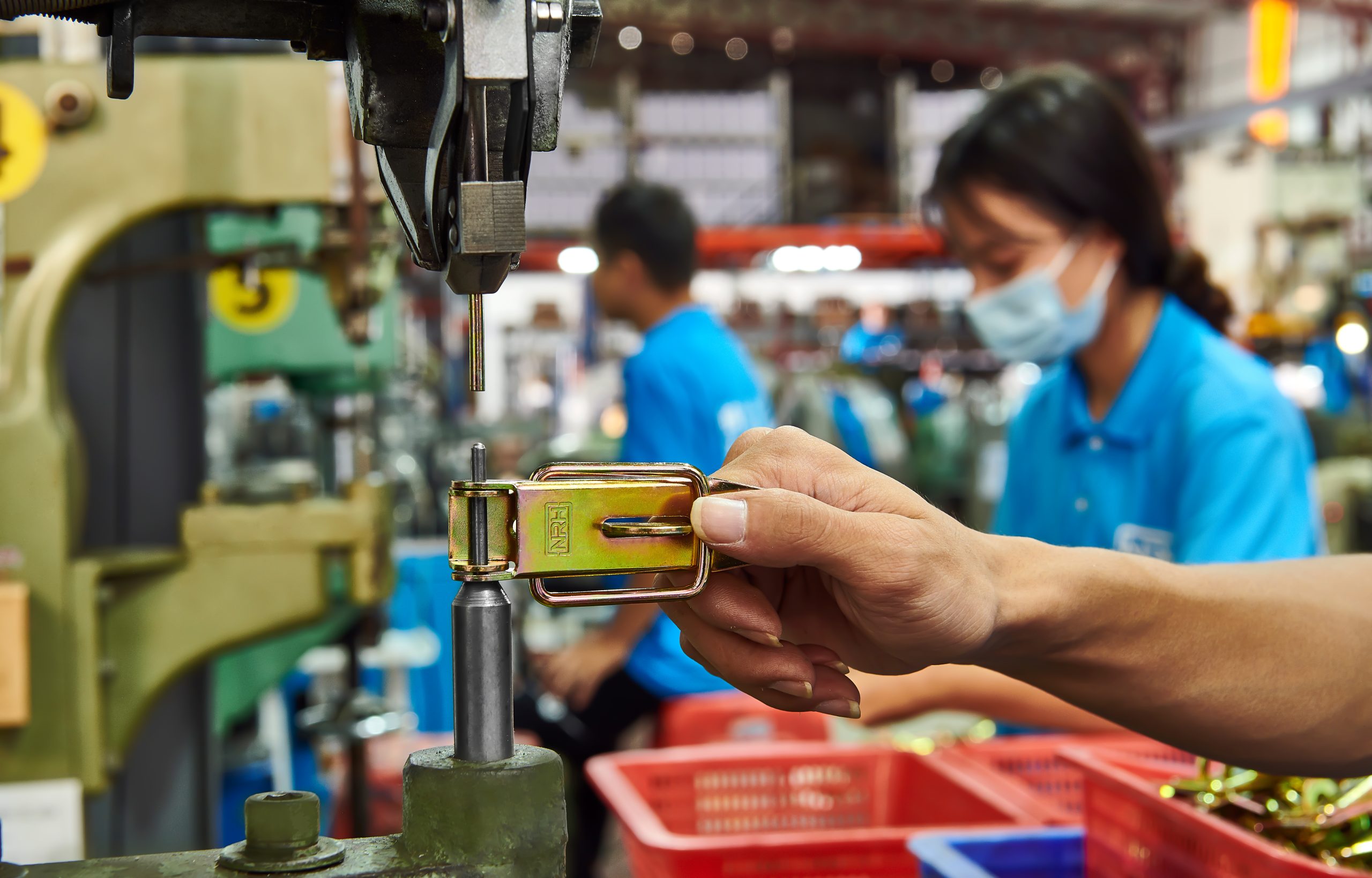 Hardware manufacturing facility production line with quality control inspection stations for case hardware components