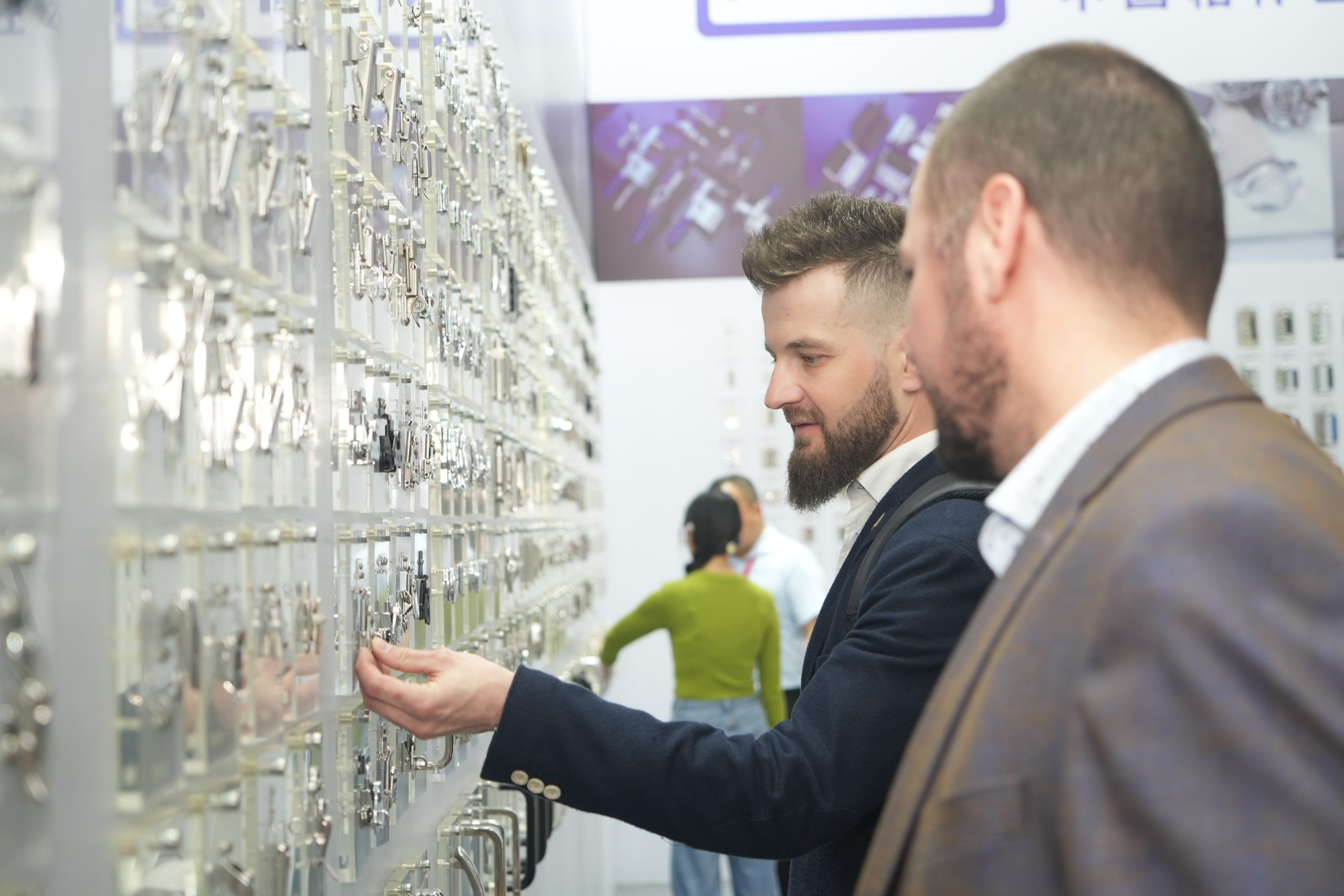 International buyers examining case hardware products and discussing specifications at NRH booth during CIFF Guangzhou 2026