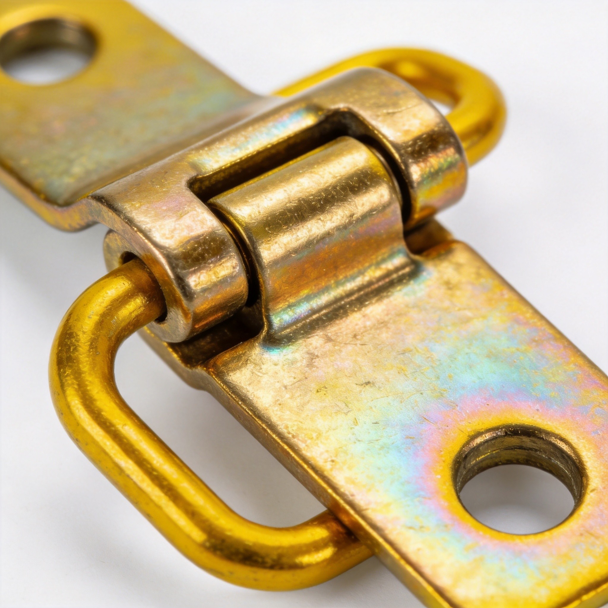 Close-up of yellow zinc plated hardware surface showing golden-yellow chromate conversion coating with iridescent sheen