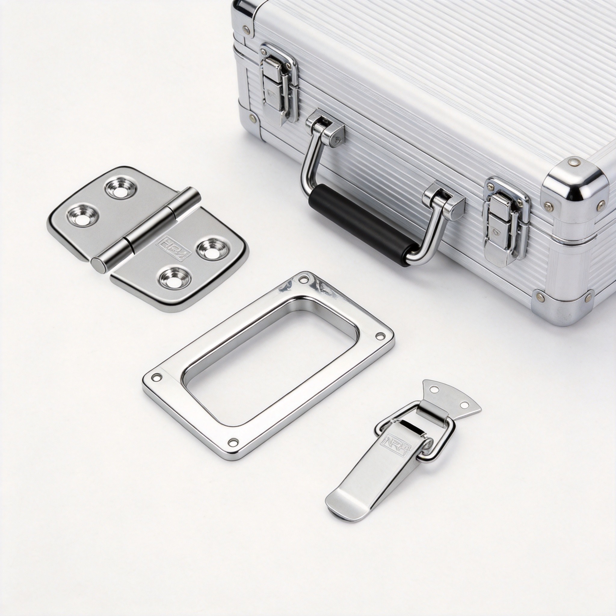 Stainless steel case hardware components including butterfly latch, recessed handle, and hinge arranged for veterinary instrument case assembly
